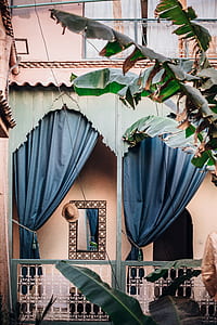 photo of curtain swag in veranda near banana plant thumbnail
