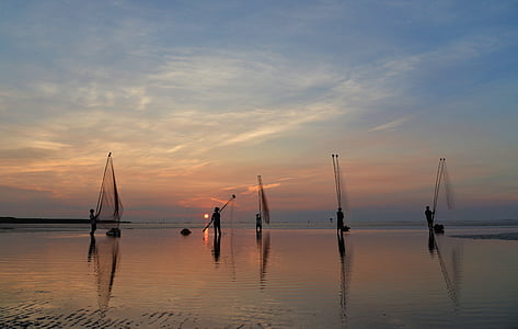 silhouette photography of person catching fish thumbnail