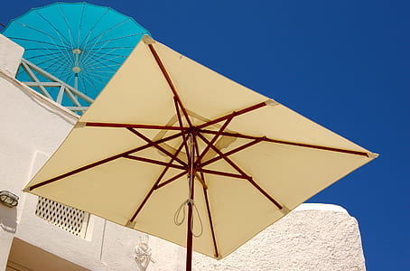 low angle photography of beige patio umbrella taken at daytime thumbnail