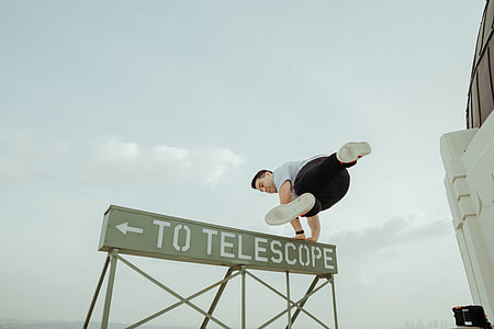 man standing on signage thumbnail