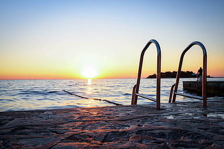 calm body of water during golden hour thumbnail