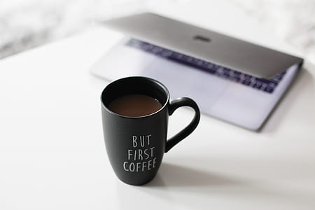 ceramic mug beside MacBook thumbnail