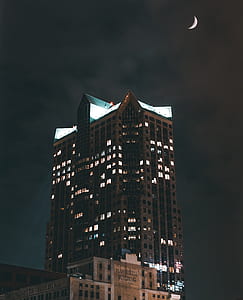 gray concrete lighted building during nighttime thumbnail
