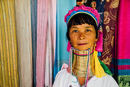 woman wearing brass-colored neck rings thumbnail