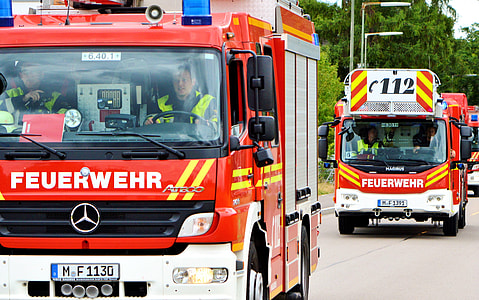 red Mercedes-Benz firetruck on gray asphalted road thumbnail