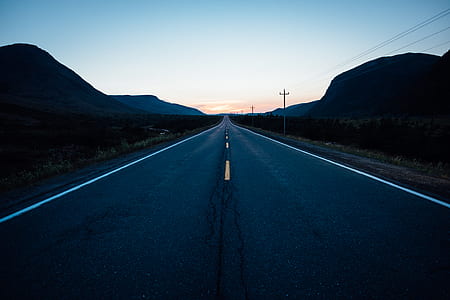 gray pave road during golden hour thumbnail