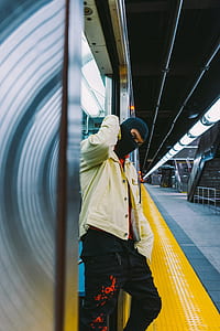 man leaning on gray stainless steel train thumbnail