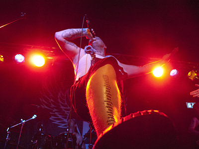 low angle photography of man holding microphone on stage thumbnail