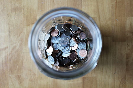 silver-and-gold-colored coins in jar thumbnail