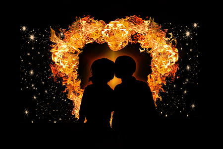 silhouette of two person with flame as back drop thumbnail