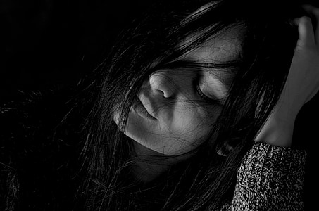 grayscale photography of woman holding her head thumbnail