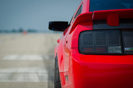 red Ford Mustang coupe on road thumbnail
