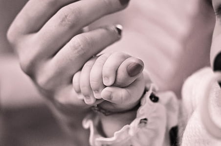 baby holding mothers finger thumbnail