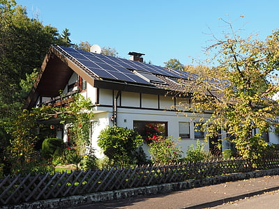 white and black painted house near green tree thumbnail