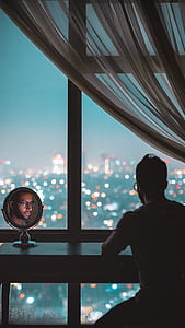man sitting infront of black table in doors thumbnail
