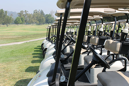 golf carts lined on golf course thumbnail