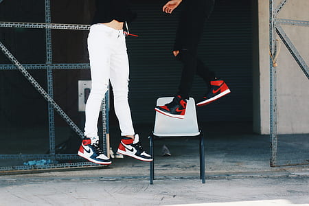 two person wearing black toe and bred Air Jordan 1 shoes floating on air thumbnail