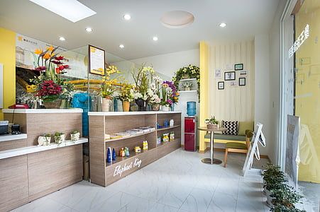 rectangular beige wooden display cabinet near red water dispenser beside yellow wall paint thumbnail