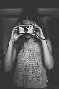 grayscale photo of woman using camera thumbnail