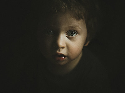 boy showing face inside deemed room thumbnail