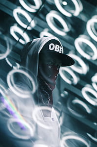person wearing grey hoodie covering mouth thumbnail