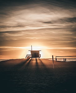 silhouette of beach house on seashore thumbnail