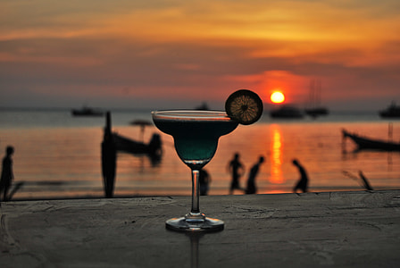 margarita glass filled with liquid during golden hour thumbnail