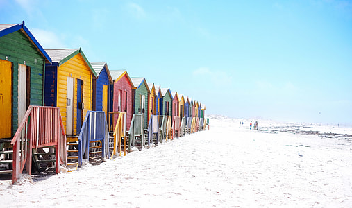blue, yellow, green Bunk houses beside seashore during day time thumbnail