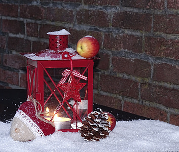 red apple fruit on lantern candle holder on snow thumbnail