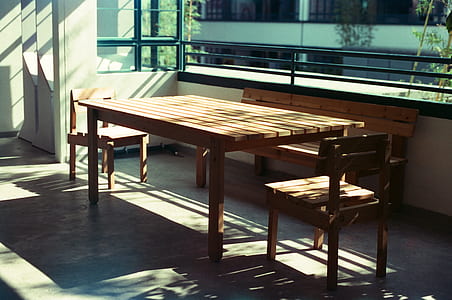 brown wooden table near wooden bench in room thumbnail