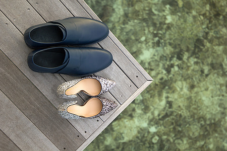 shallow focus photography of pair of black leather shoes and gray pointed-toe shoes thumbnail