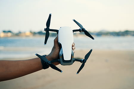 Person Holding White And Black Quadcopter Drone thumbnail