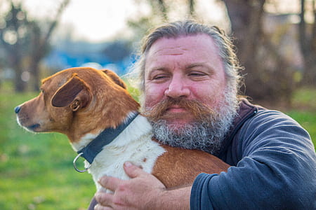 man hugging the tan and white dog thumbnail