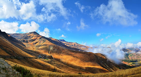 time lapse photography of clouds over hills thumbnail