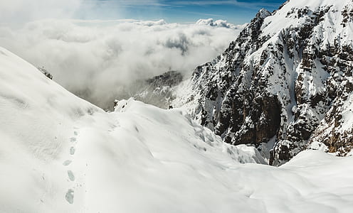 snow-covered mountains and field under blue clear sky during daytime thumbnail