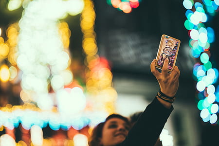woman holding smartphone taking selfie thumbnail