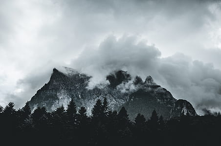 grayscale photography of mountains covered in fog thumbnail