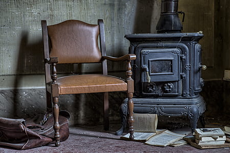 brown wooden armchair beside black wood burner thumbnail