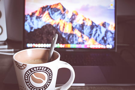 Photo of Cup of Coffee in Front of the Laptop thumbnail