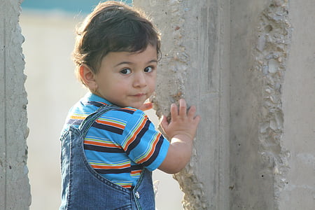 closeup photography of boy touching concrete wall during dayti8me thumbnail