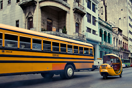 Retro street photo of a public bus and coco taxi, shot taken in Havana, Cuba thumbnail
