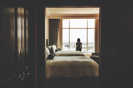woman in black shirt standing in front of window thumbnail