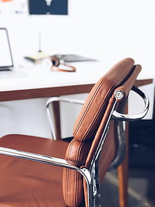 macro shot of brown leather armchair with stainless steel frame thumbnail