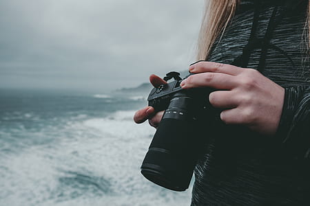 person holding black DSLR camera thumbnail