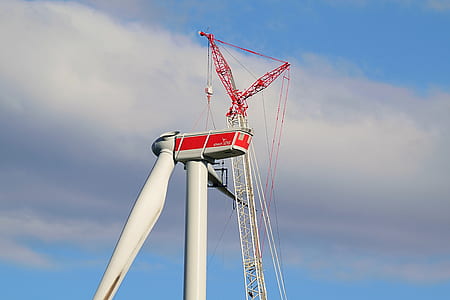 black and red windmill under blue sky thumbnail