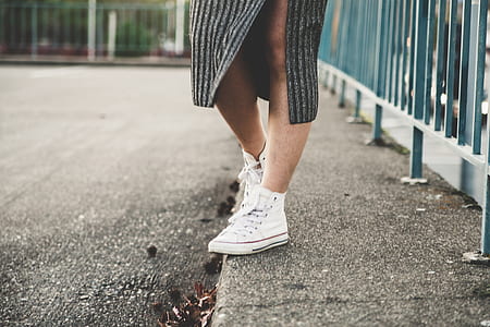 person wearing white high-top sneakers thumbnail