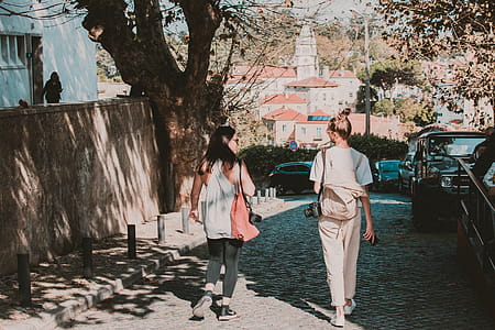 Two Women Walking by Tree thumbnail