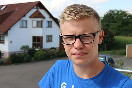 man in blue shirt standing outside the the house thumbnail