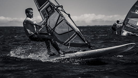 man windsurfing grayscale photography thumbnail