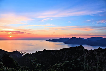 mountains beside body of water thumbnail